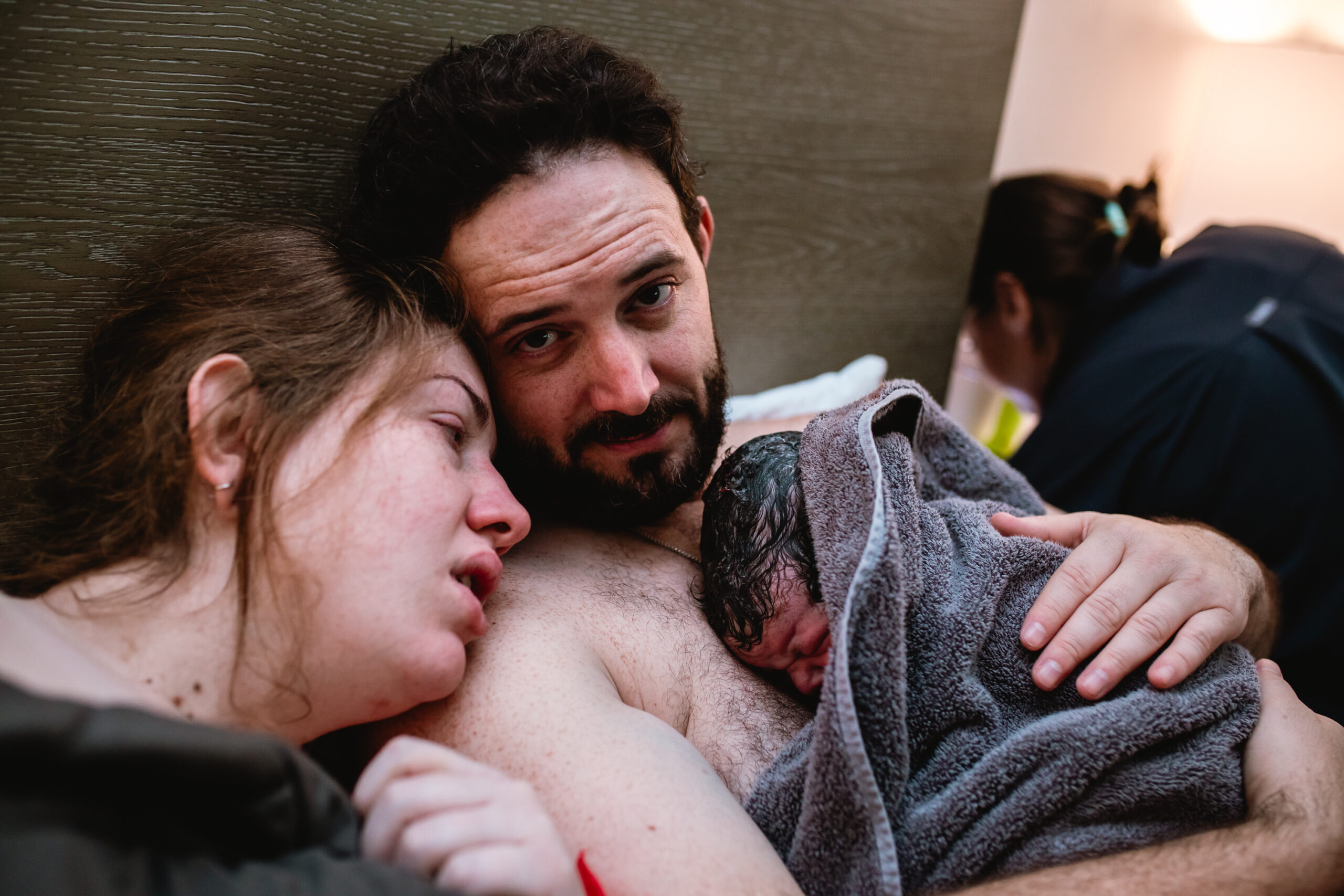 Mother and father holding their newborn skin-to-skin together moments after birth.Select 87 more words to run Humanizer.