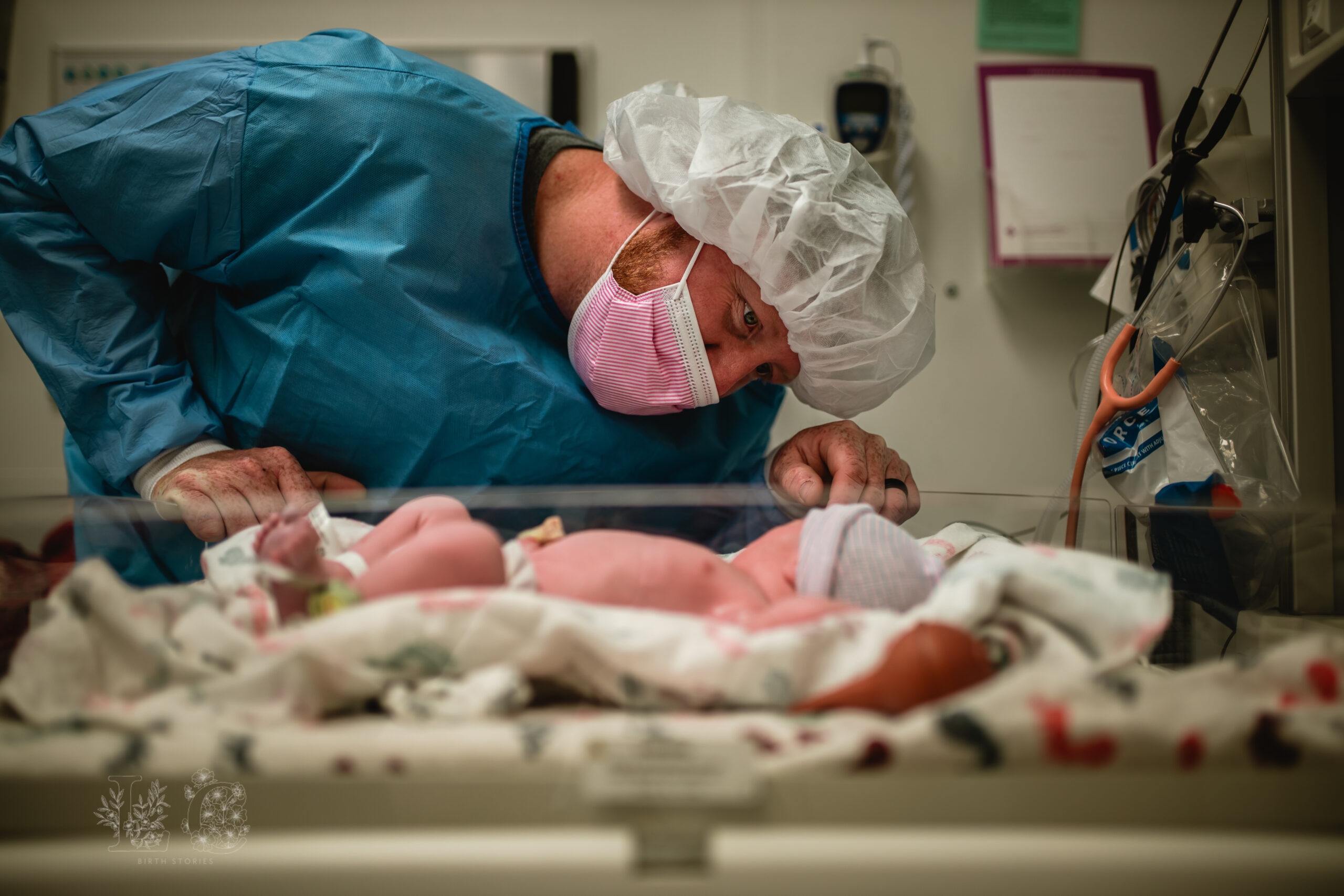 Father meeting his newborn in the operating room moments after a C-section at a Fort Worth hospital.