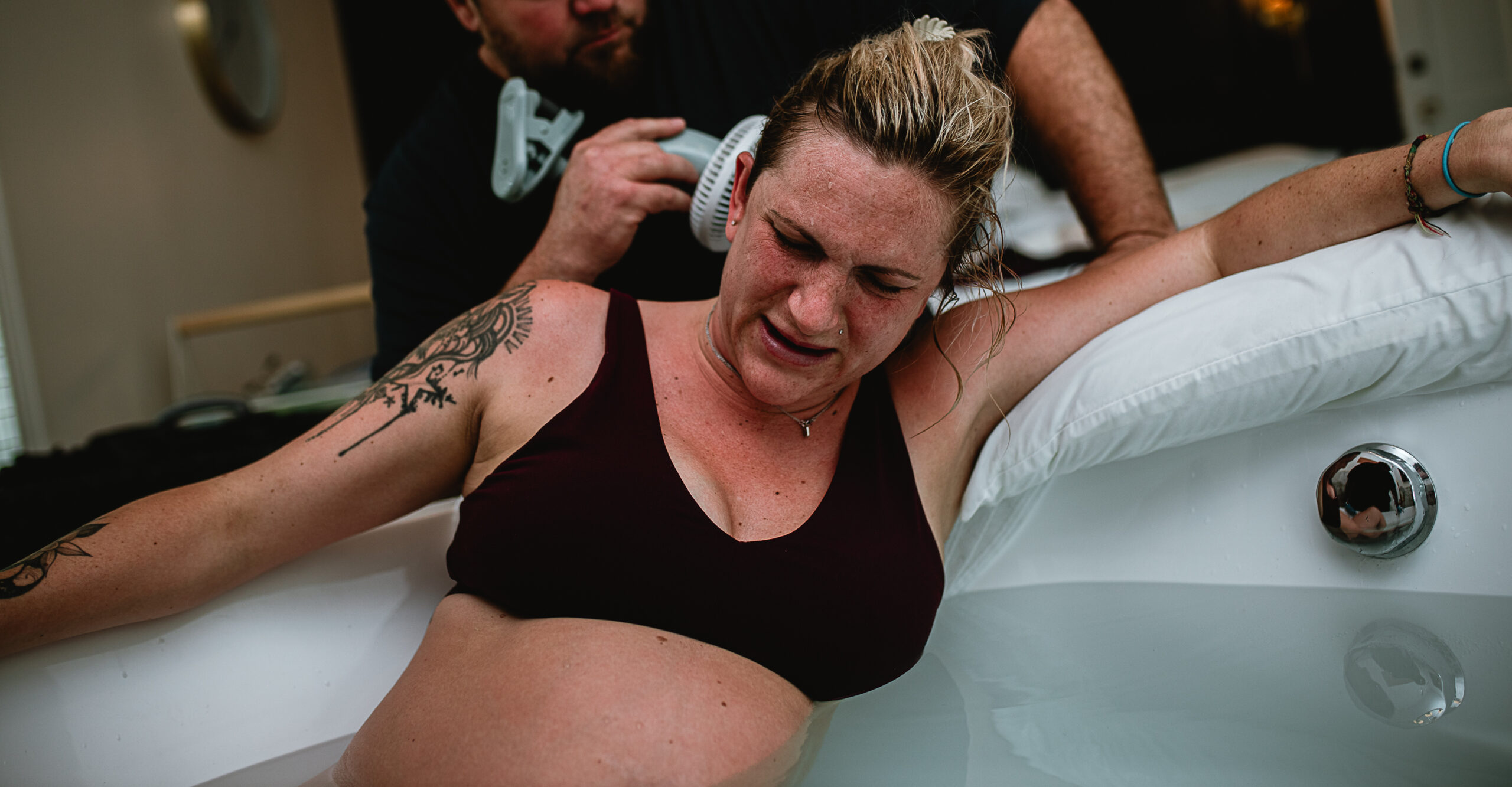 Mother in active labor with her partner nearby during a Fort Worth birth, documenting the stage when birth photographers typically arrive in DFW.