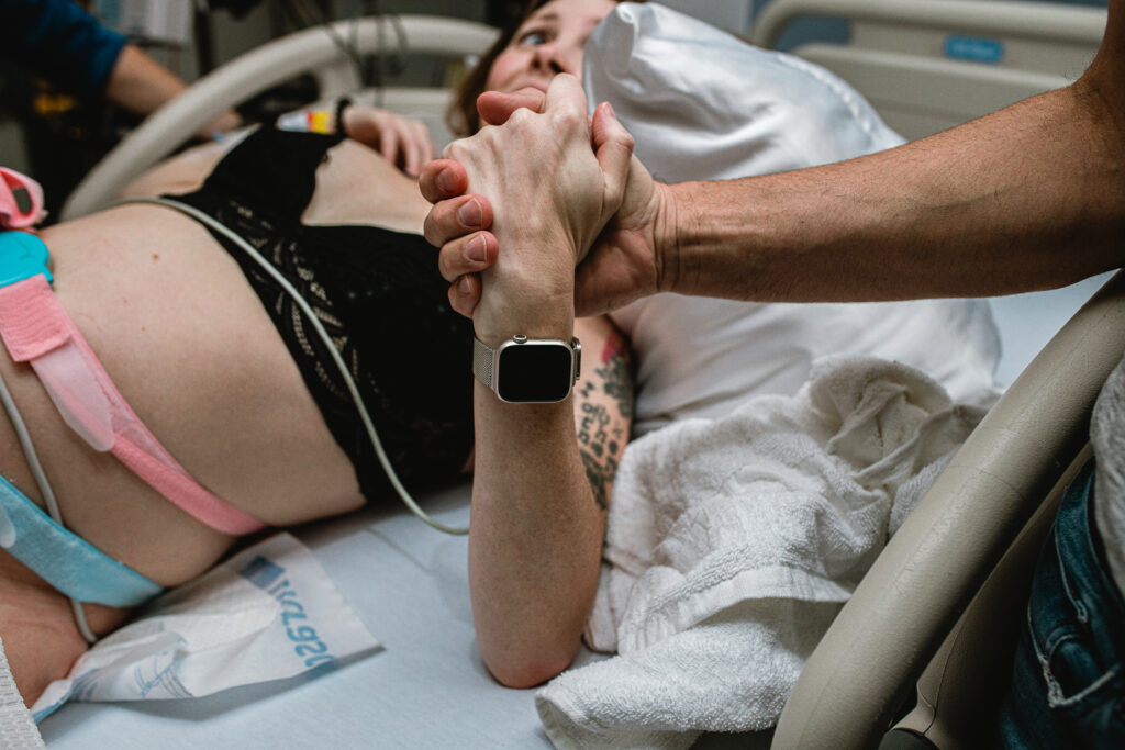 Partner supporting mother during labor at a Fort Worth birth, documented by a DFW birth photographer.
