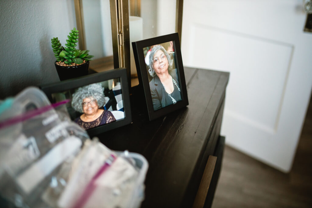 Memory table with framed family photos and keepsakes set up inside the birth center