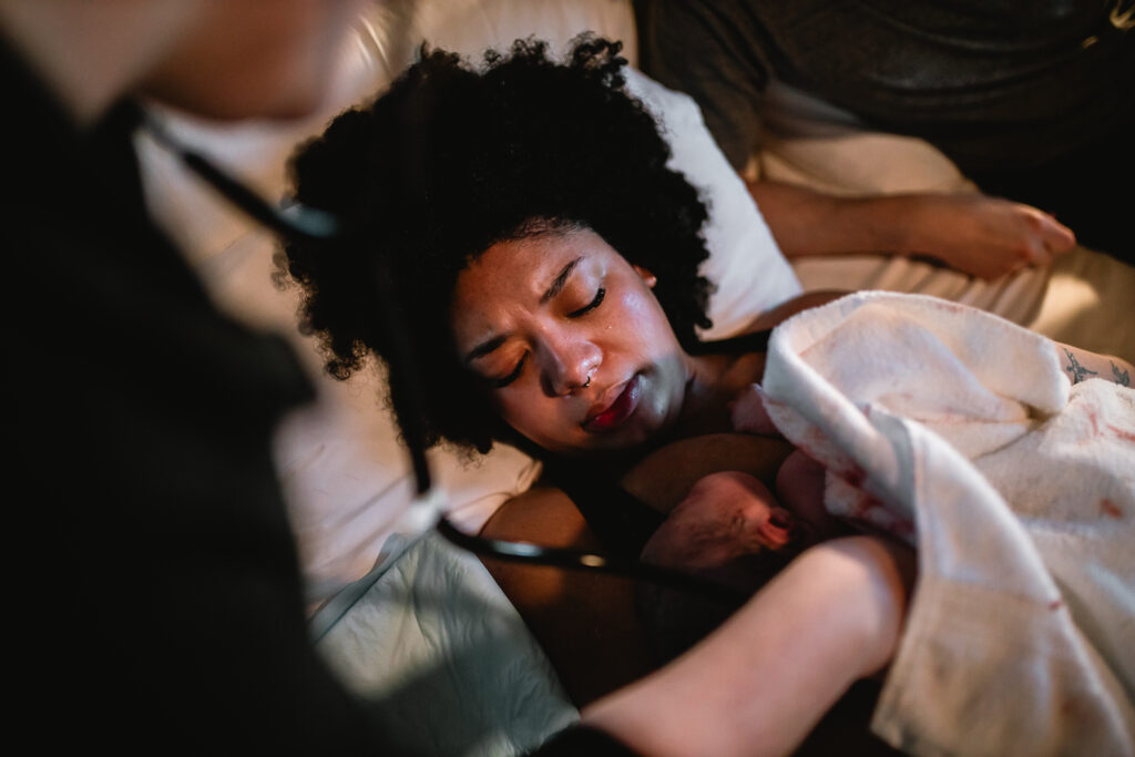 Mother resting peacefully with her newborn snuggled close against her chest