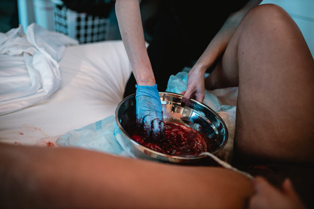 Midwife performing newborn assessments while the mother holds her baby on her chest