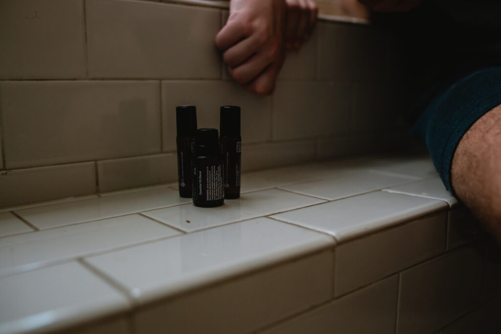 Home birth detail — essential oils on bathroom ledge during labor