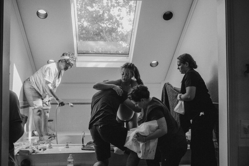 Birth partner helping mother change positions during active labor