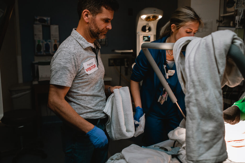Mother adjusting her position in the hospital bed while preparing for the next contraction