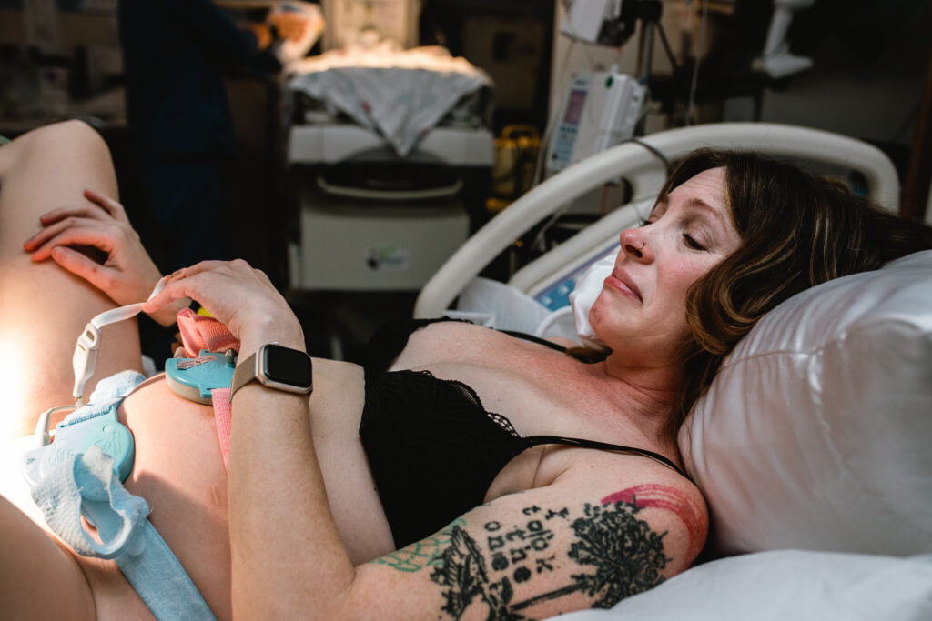 First time mom breathing between pushes while laboring in a hospital delivery room