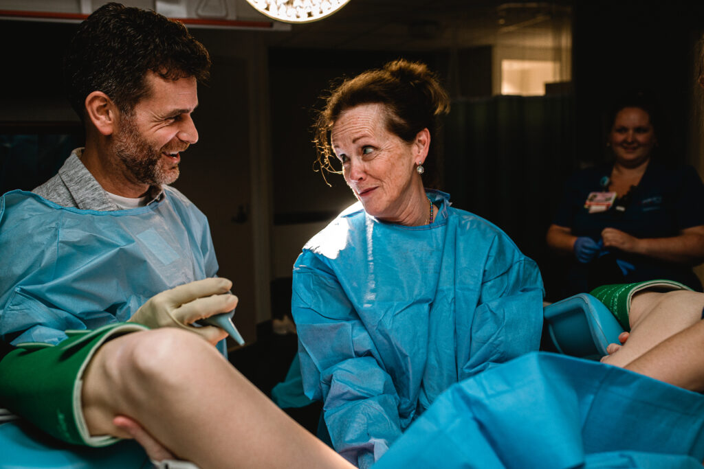 Mother and father locking eyes and sharing a supportive moment together during pushing stage of labor