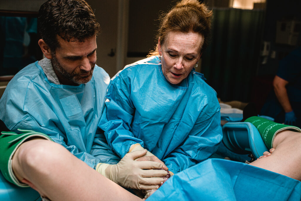 Father holding his newborn baby for the very first time moments after birth