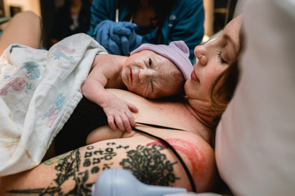 Mother holding her newborn baby skin-to-skin on her chest moments after birth inside a Fort Worth hospital room