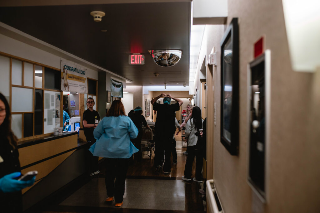 Emotional labor moment during an unexpected turn in birth, documented by a Fort Worth birth photographer in a storytelling style.