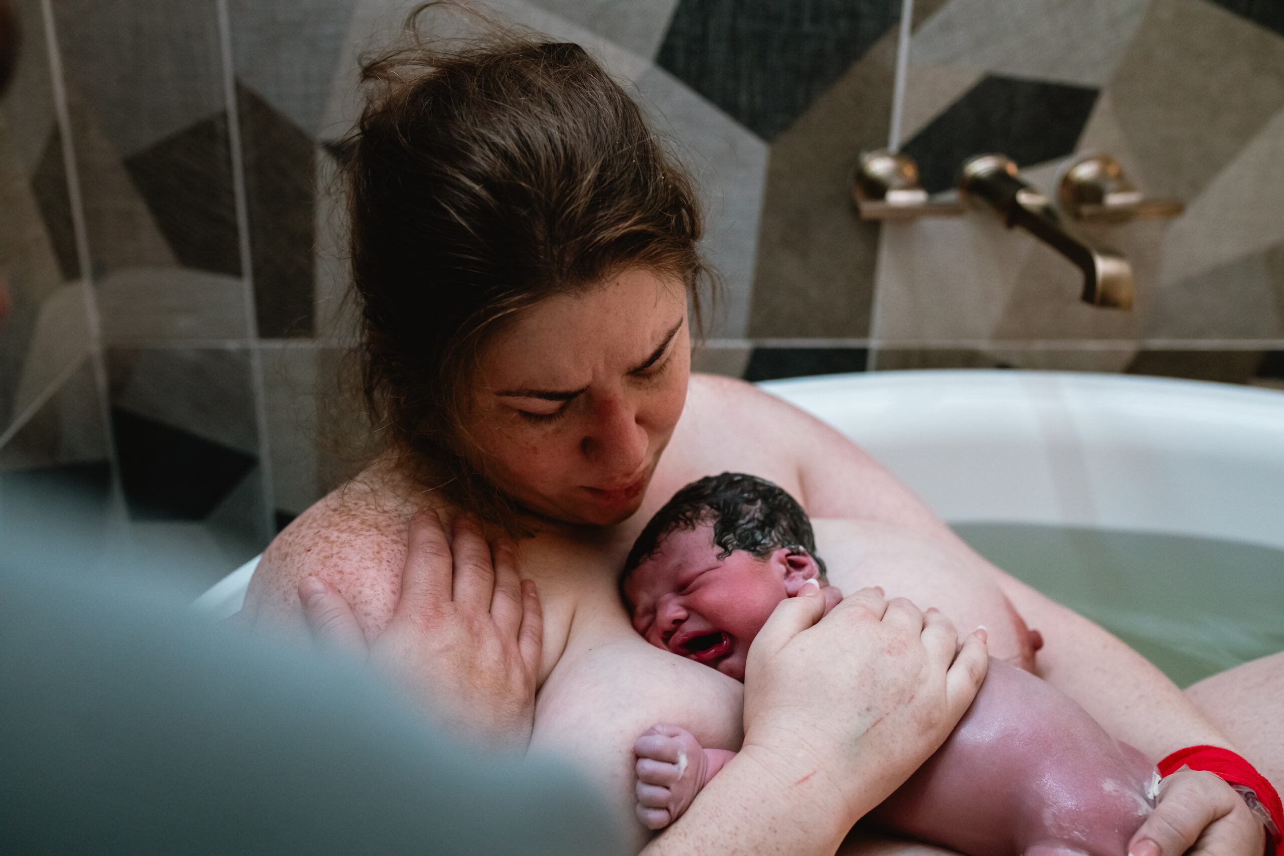 Newborn placed on mother’s chest during the first hour after birth in Fort Worth, captured in a quiet and emotional skin-to-skin moment.