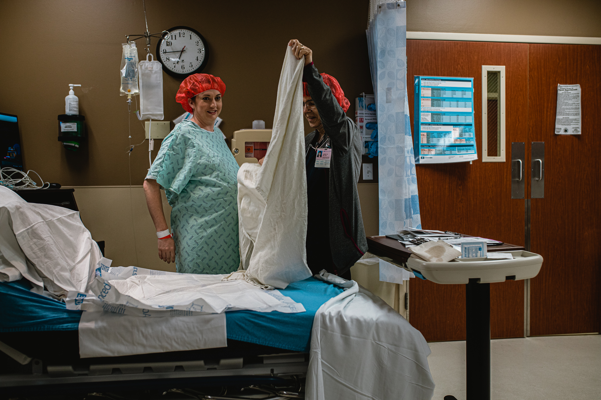 Mother holding her newborn after a scheduled C-section in Fort Worth, captured in a calm and emotional birth photography moment.