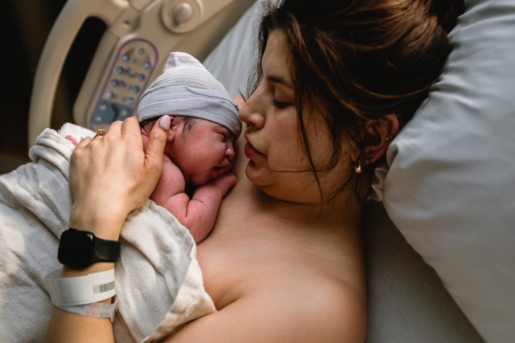 Newborn resting on mother's chest during the first hour after birth.