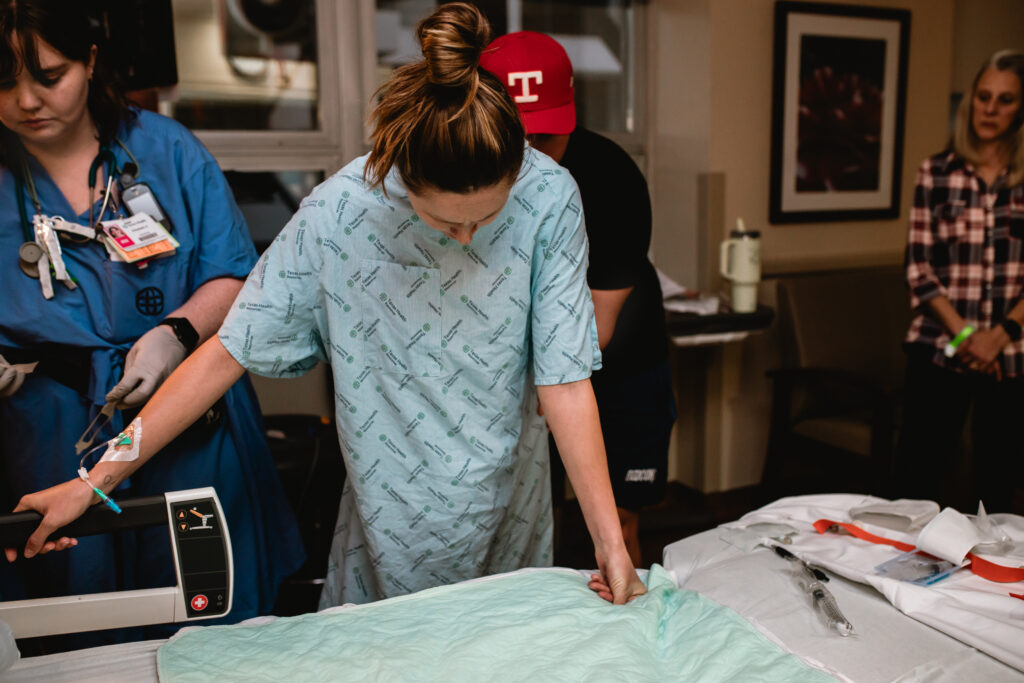 Partner comforting a laboring mother before the birth of their baby.