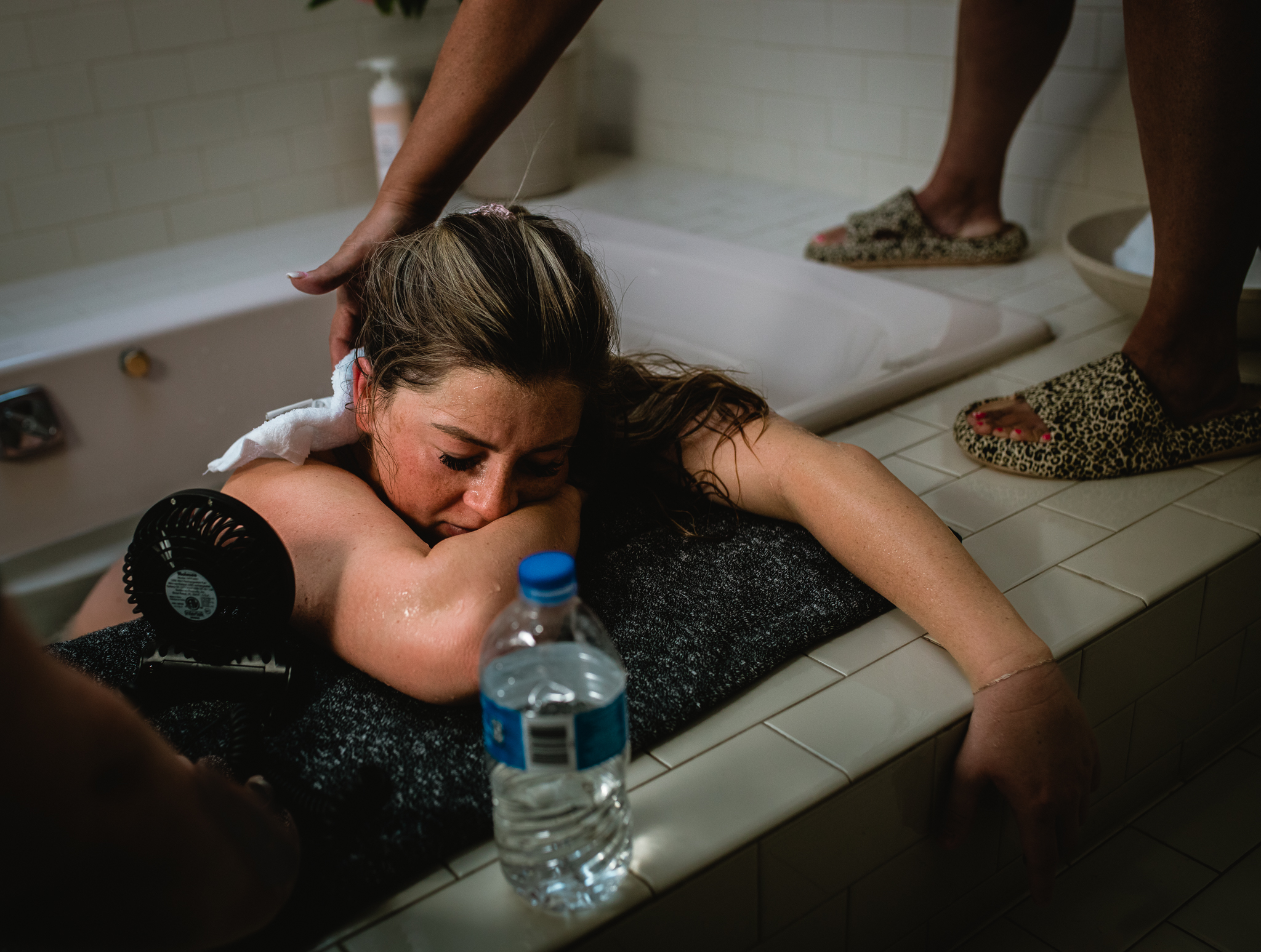 Mother quietly laboring with her partner by her side during childbirth.